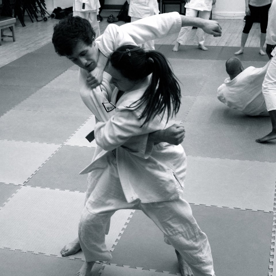 A student throwing their opponent with Tai Otoshi (body drop)